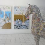 two paintings and horse sculpture