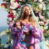 Beyoncé birth announcement photo by Awol Erizku - showing Beyoncé surrounded by colorful flowers, holding her twins.